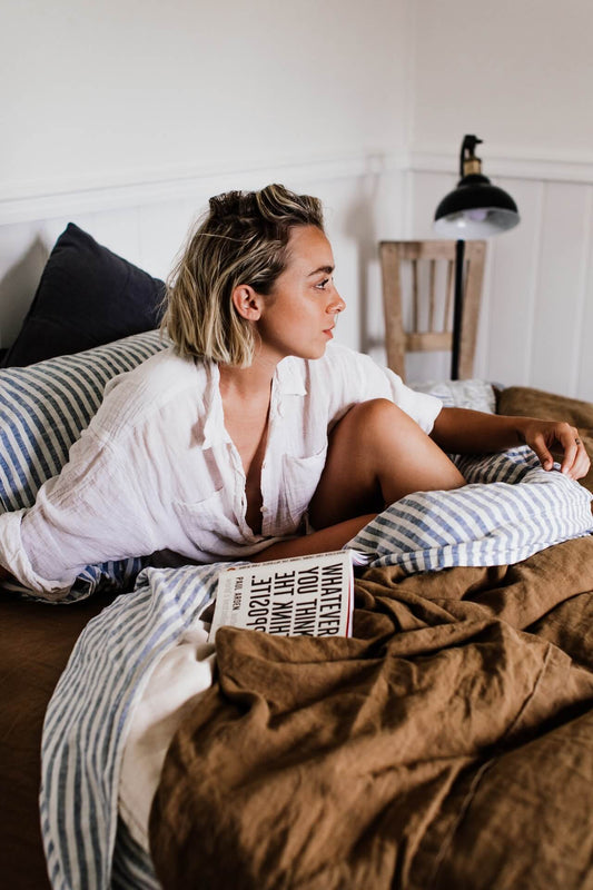 Creative lady productively lying in bed