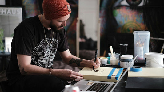 Man painting in a colourful art studio, absorbed and deliberate, living with intention