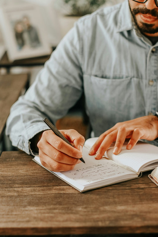 Person keeping a simple travel journal to protect memories of their trip
