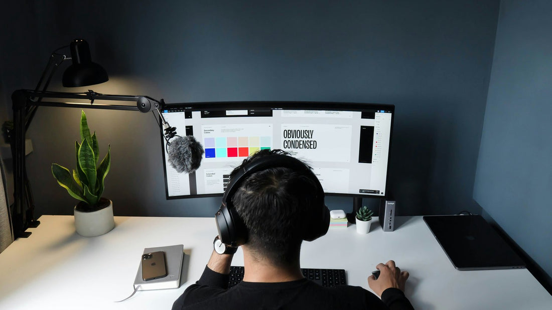 Person at an ultrawide monitor with headphones in a dark home office, hyperfixation is the ADHD brain locking in with extraordinary depth and intensity