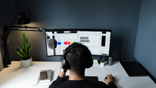 Person at an ultrawide monitor with headphones in a dark home office, hyperfixation is the ADHD brain locking in with extraordinary depth and intensity