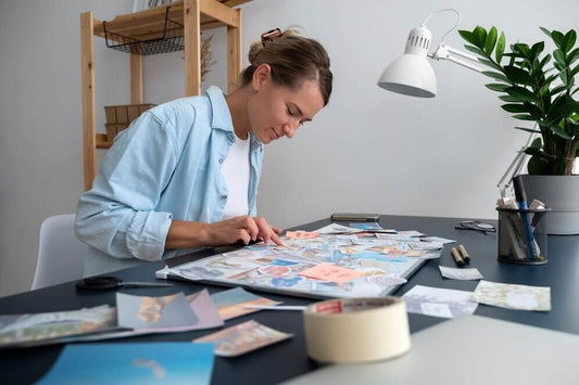 Woman arranging images on her vision board while thinking through her goals for the year