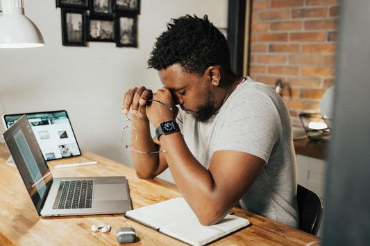 Stressed creative entrepreneur writing in his journal