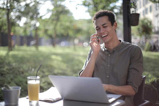 creative entrepreneur sat on the phone on the desk