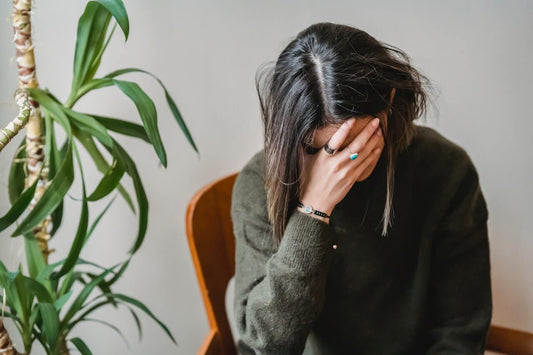 creative lady with her head in her hands struggling with burnout