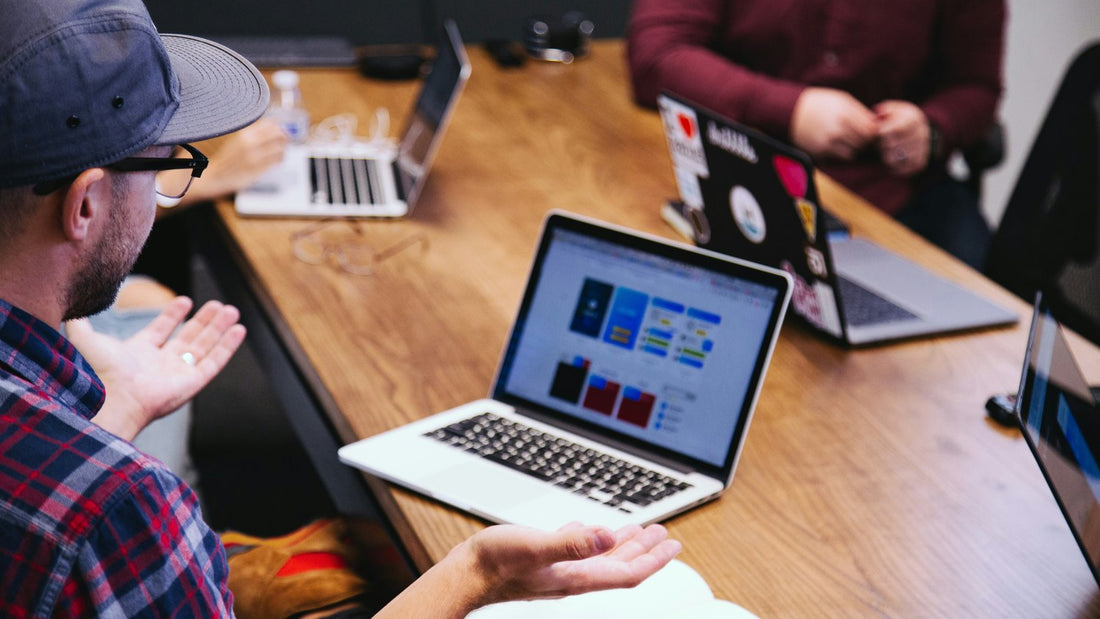 Notes and papers spread across a desk mid-task, the visual of work that perfectionism never lets feel finished