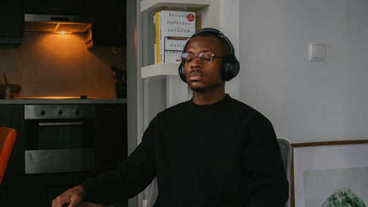 Person journaling calmly at a desk in soft light, reflecting for self-discovery