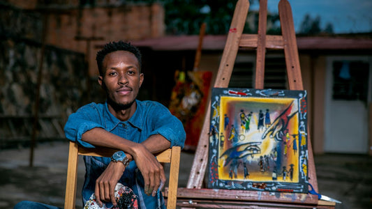 Man sitting calmly alone with his artwork outdoors, valuing his own quiet solitude