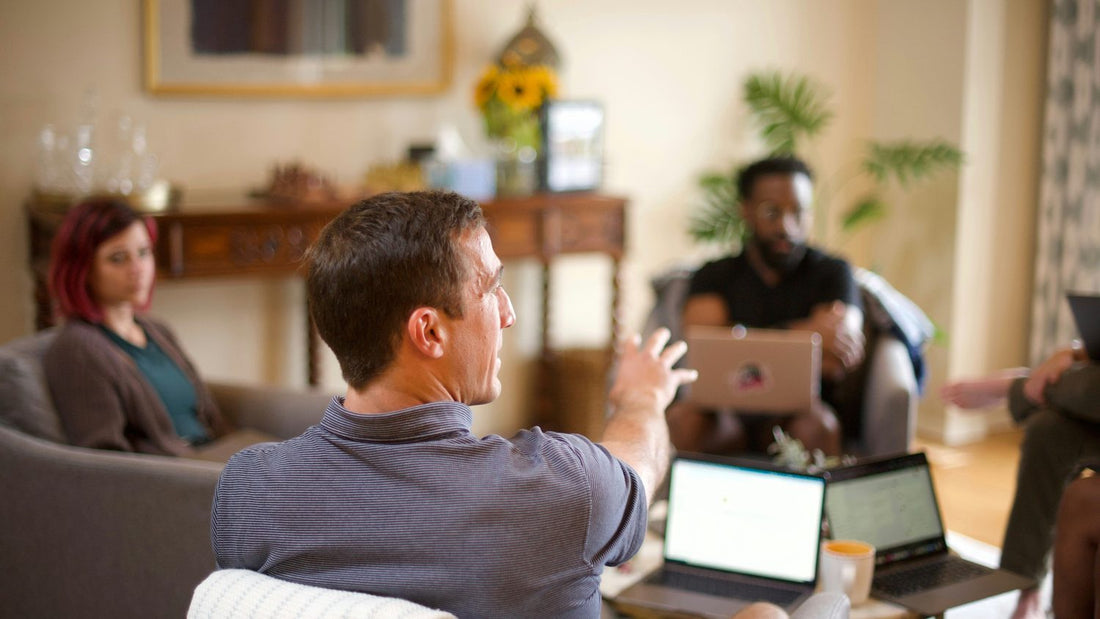 Colleagues in a calm, direct workplace conversation — the kind of clear exchange a work boundary depends on
