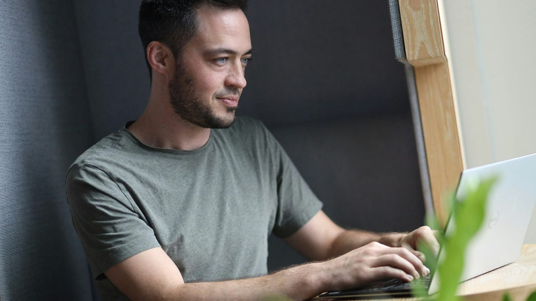 Person sitting at a dimly lit desk looking mentally exhausted, unable to focus despite feeling rested