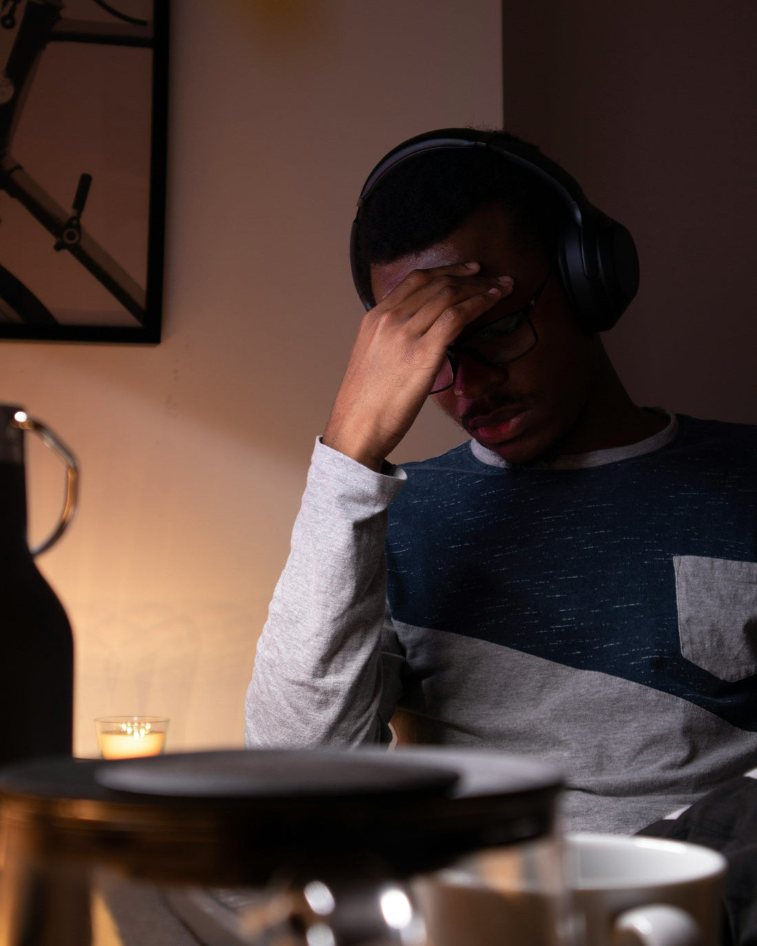 Man staring at a laptop screen late at night, unable to switch off from work despite the hour