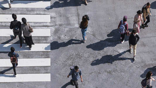 Aerial view of a busy pedestrian crossing with people moving in every direction, the time pressure of a full day
