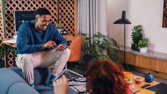 Man relaxing calmly with a tablet in a stylish lounge setting, benefits of a settled daily routine