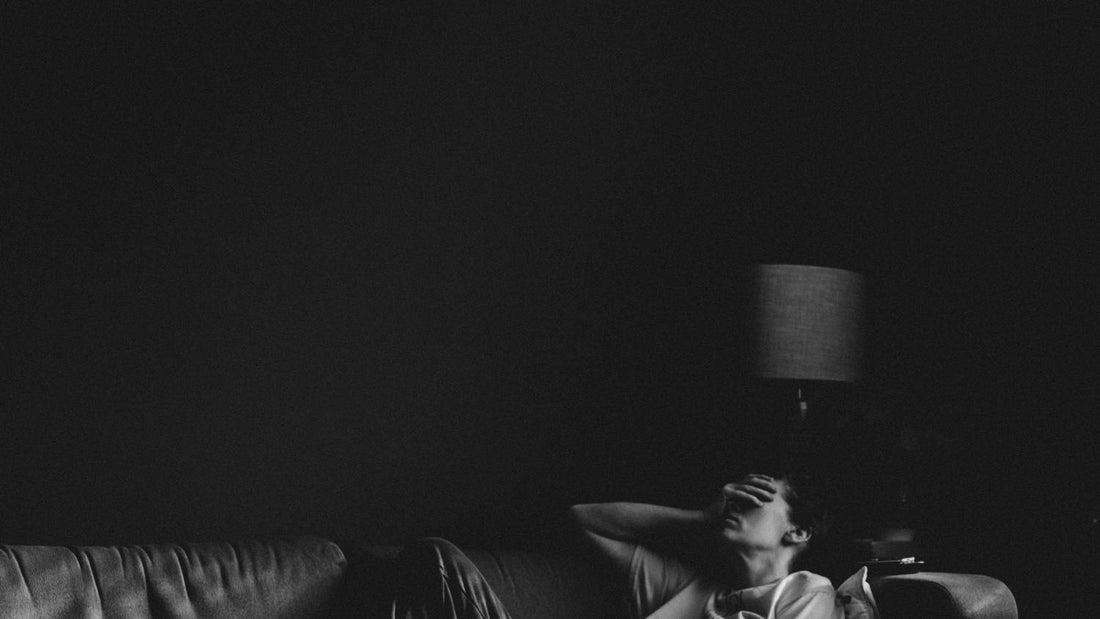Person sitting peacefully in natural light, exploring the science of self-compassion and productivity