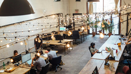 Overhead view of a busy coworking space with people working at desks