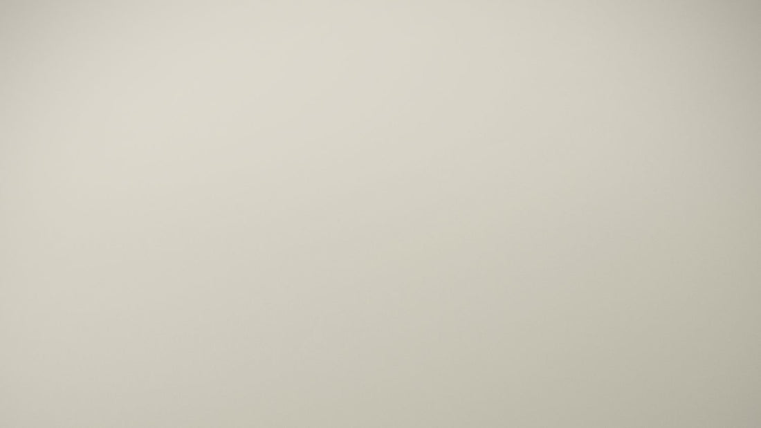 Person sitting quietly alone in soft light, the exhausted stillness characteristic of autistic burnout