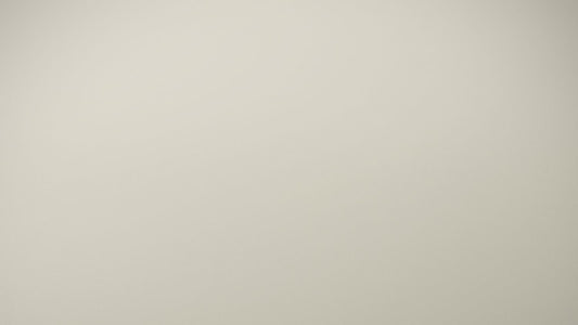 Person sitting quietly alone in soft light, the exhausted stillness characteristic of autistic burnout