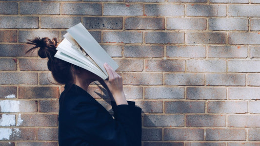 Person reading quietly outdoors, reflecting on nervous system dysregulation and feeling wired and tired at the same time