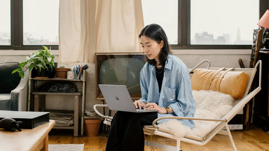 Woman working at a bright home desk, planning her week ahead with focus