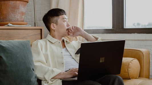 Man sitting at a desk, pausing to think before responding to a difficult message