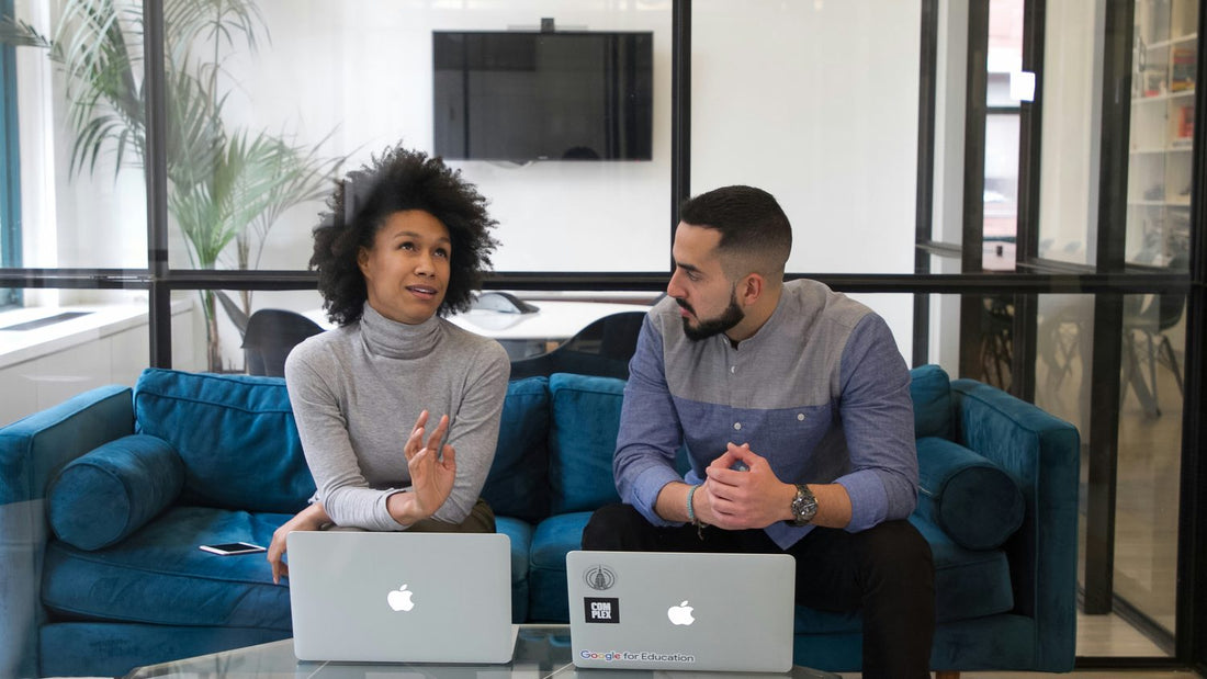 A couple sitting together discussing plans calmly, sharing the mental load in their relationship