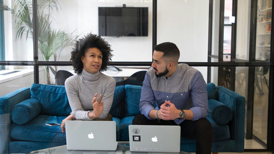 A couple sitting together discussing plans calmly, sharing the mental load in their relationship