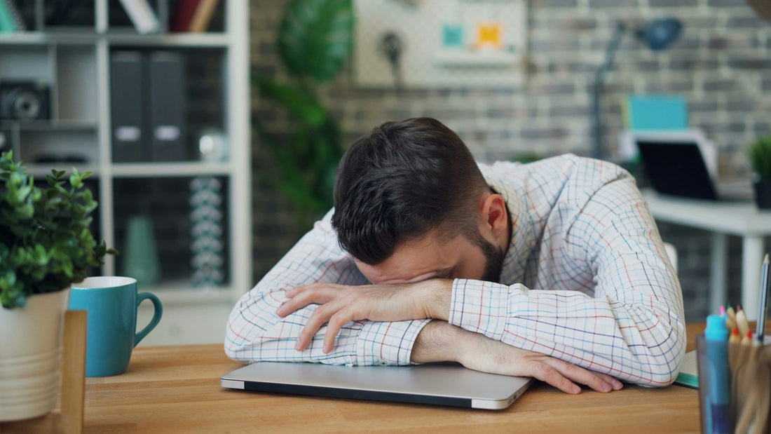 Person writing notes while reviewing figures at a desk, using a finance planner consistently