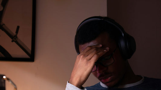 Man sitting at a desk with his head in his hands, stuck in front of an overwhelming to-do list — the ADHD planning problem this guide is written to solve