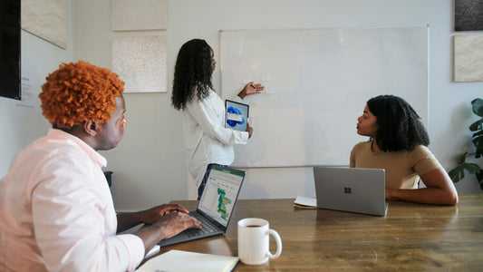 Woman with headphones focused at her laptop in a quiet office pod — the individual concentration that effective focus strategies are designed to protect